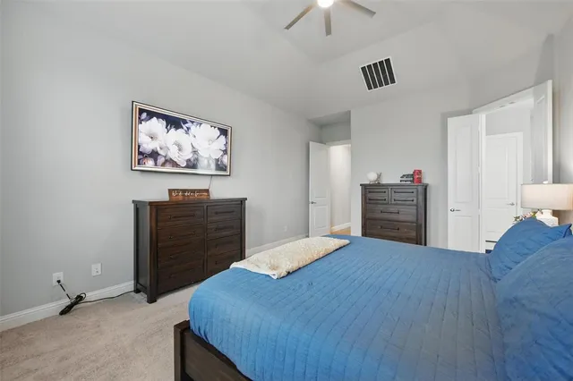 a bedroom with a bed dresser and a window