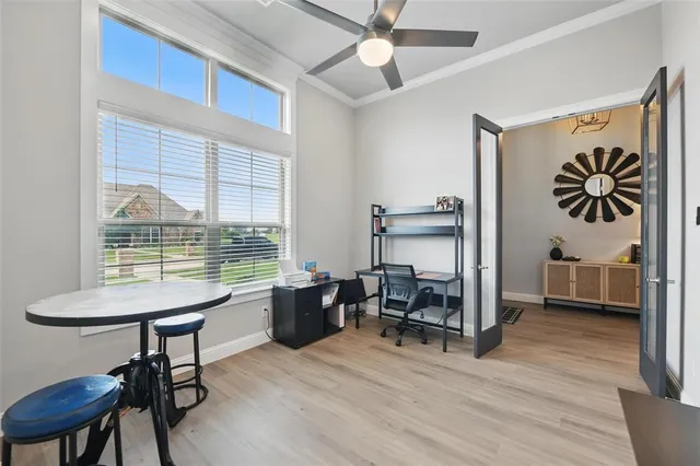 a view of a workspace with furniture and a window