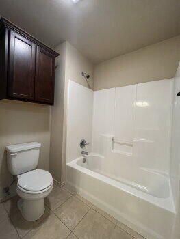 3205 112th Street Lubbock, TX 79423 - Photo 13 of 19 a bathroom with a toilet a sink and bathtub