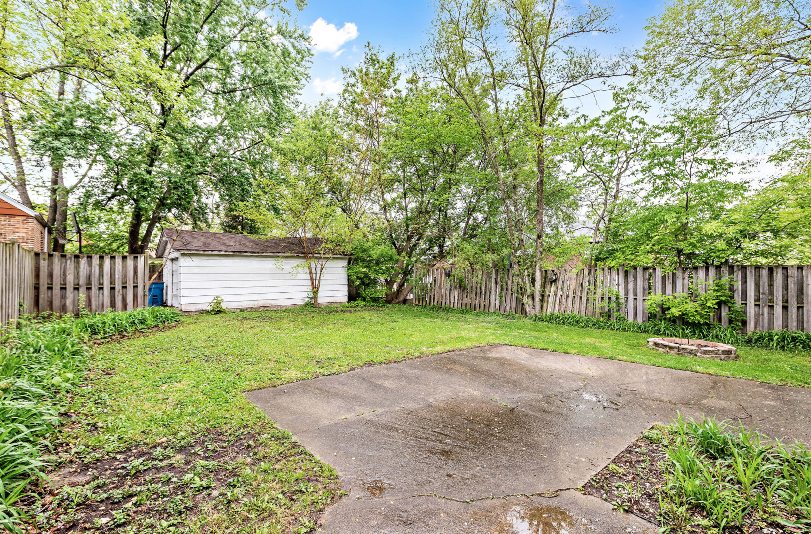 389 West 12th Street Chicago Heights, IL 60411 - Photo 14 of 15 a view of a backyard with large trees and wooden fence