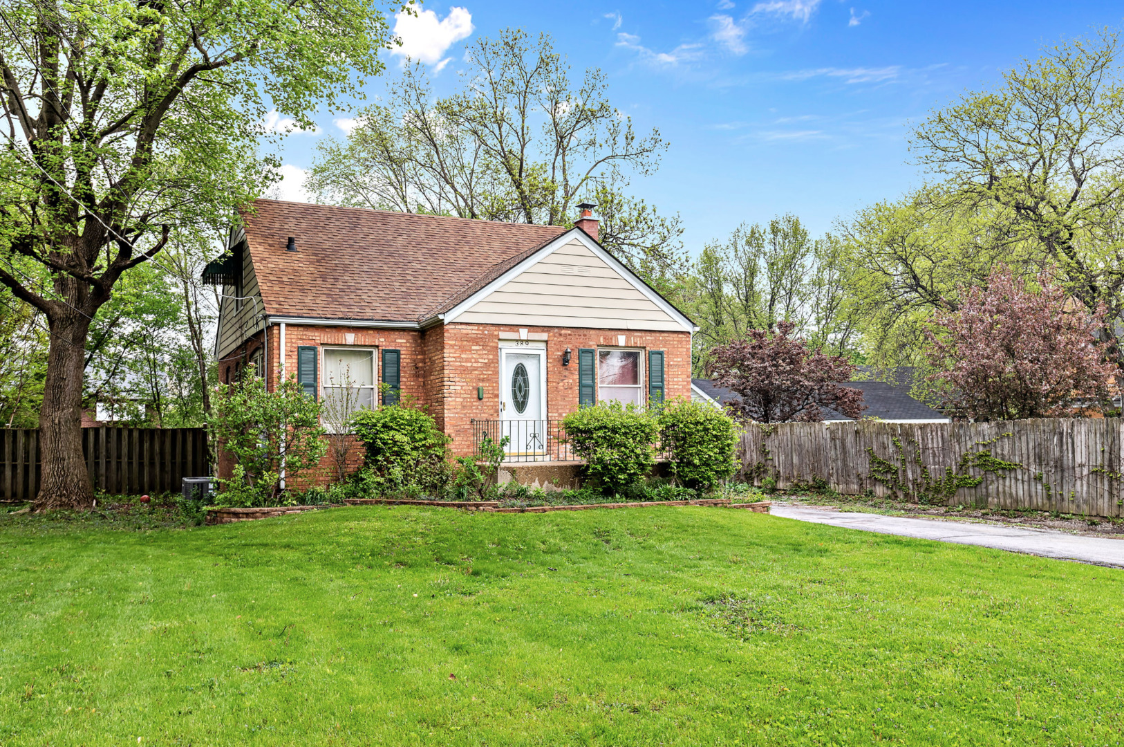 389 West 12th Street Chicago Heights, IL 60411 - Photo 2 of 15 a front view of a house with a yard and trees
