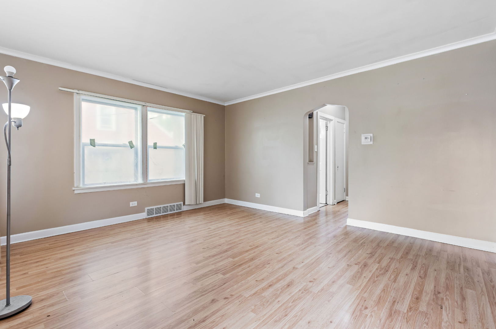 389 West 12th Street Chicago Heights, IL 60411 - Photo 4 of 15 an empty room with wooden floor and windows