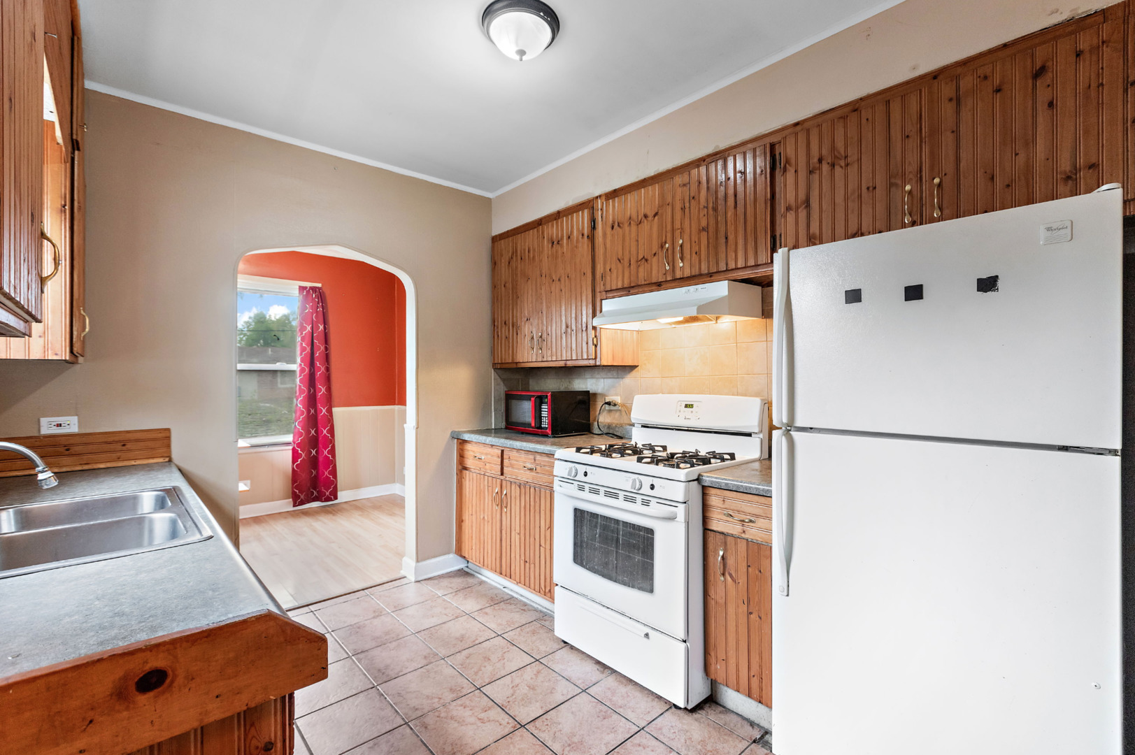389 West 12th Street Chicago Heights, IL 60411 - Photo 6 of 15 a kitchen with stainless steel appliances granite countertop a refrigerator sink stove and white cabinets