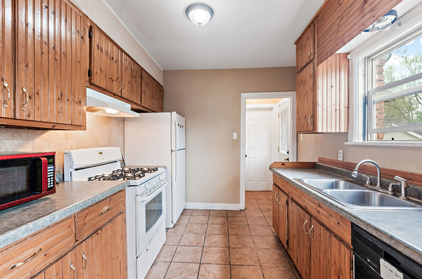 389 West 12th Street Chicago Heights, IL 60411 - Photo 7 of 15 a kitchen with stainless steel appliances granite countertop a sink stove and cabinets