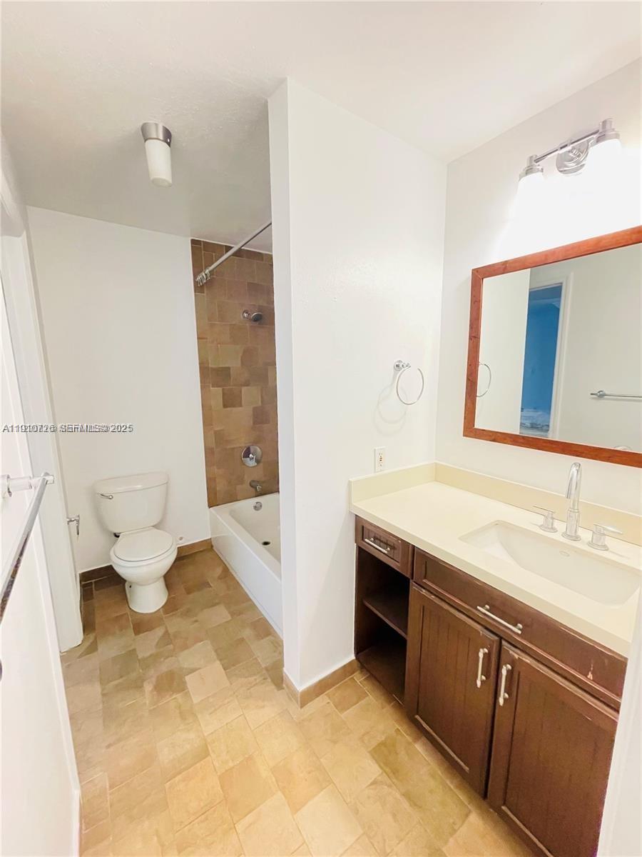 4086 North Pine Island Road, Unit 508 Sunrise, FL 33351 - Photo 11 of 13 a spacious bathroom with a granite countertop sink and a mirror