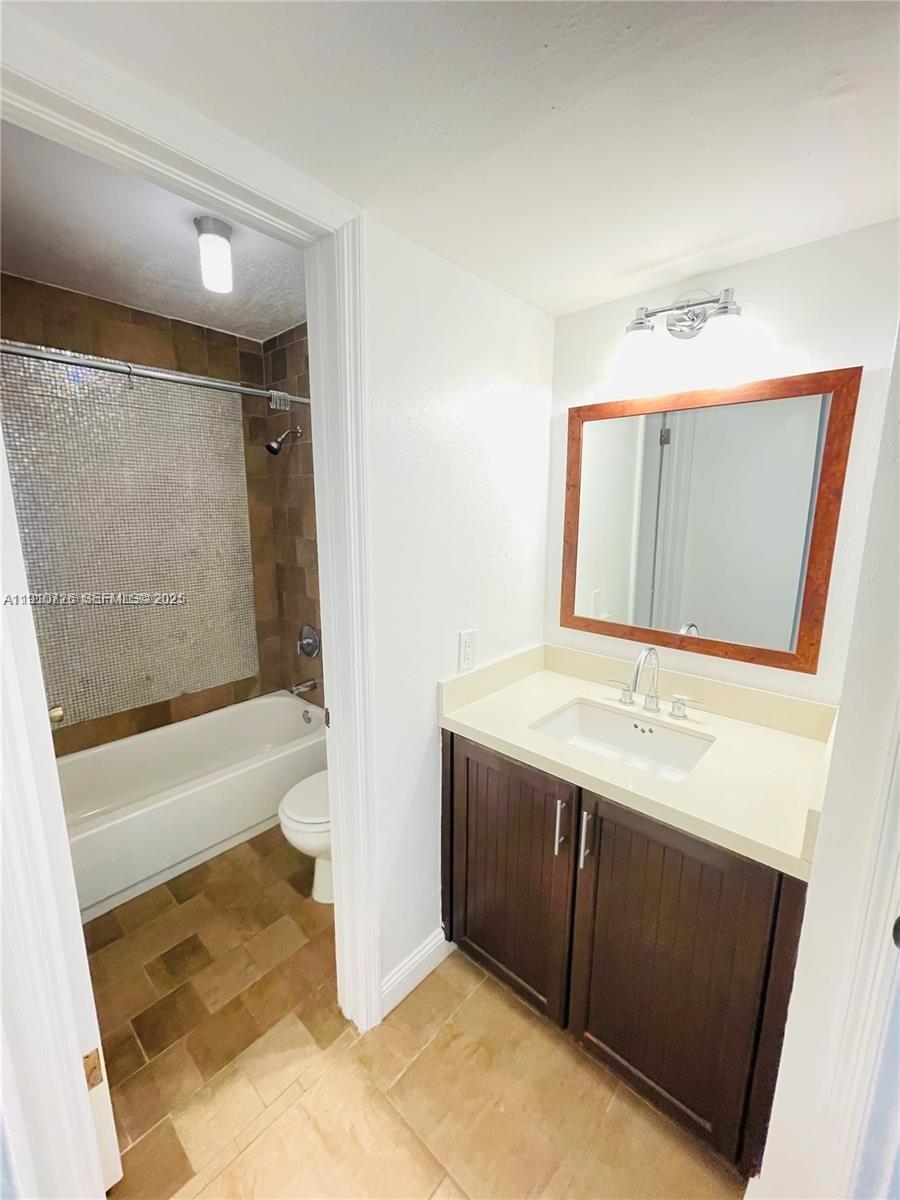 4086 North Pine Island Road, Unit 508 Sunrise, FL 33351 - Photo 13 of 13 a bathroom with a sink and a mirror