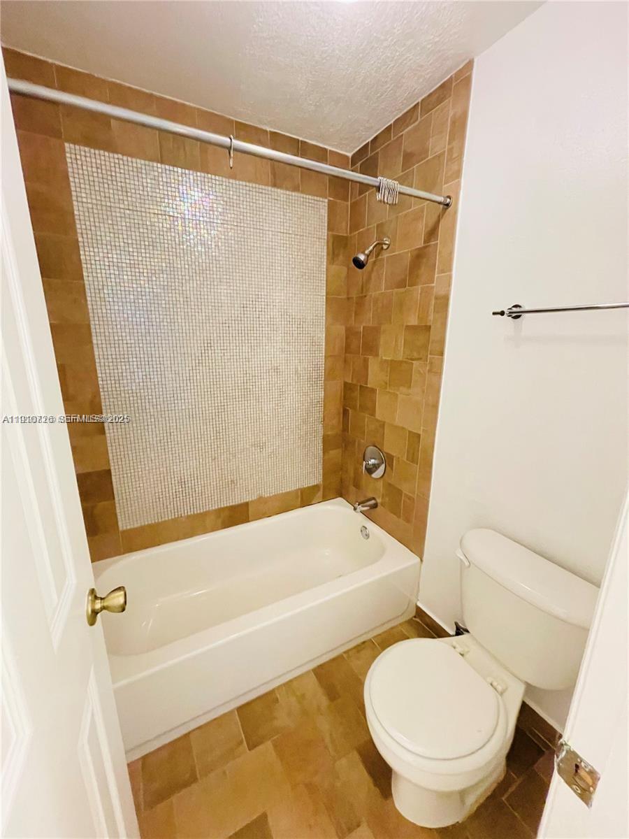 4086 North Pine Island Road, Unit 508 Sunrise, FL 33351 - Photo 5 of 13 a bathroom with a sink toilet and shower