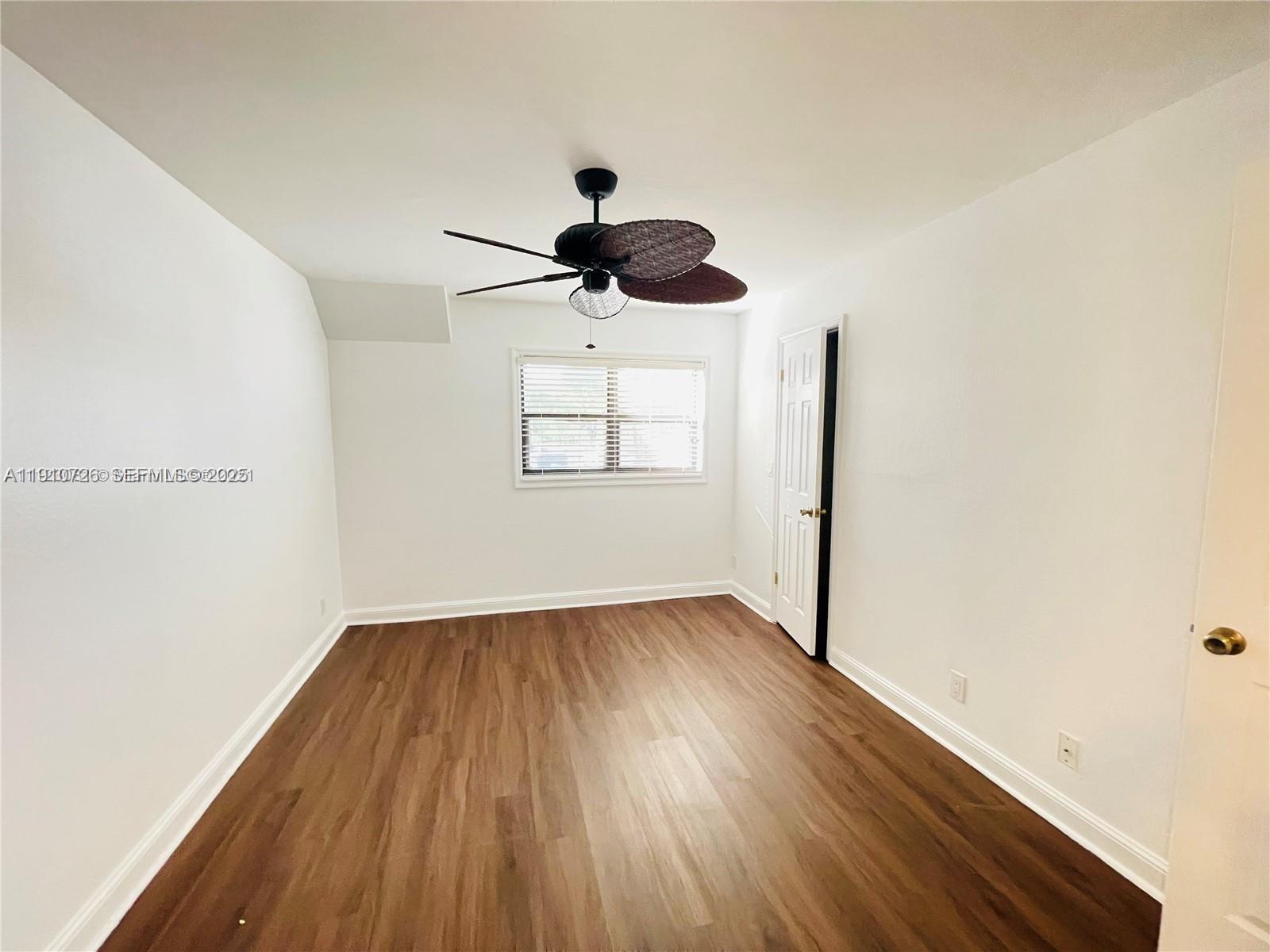 4086 North Pine Island Road, Unit 508 Sunrise, FL 33351 - Photo 10 of 13 a view of empty room with wooden floor and fan