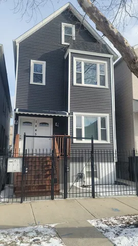 a front view of a house with a fence