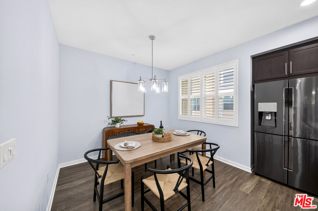 676 Colorado Circle Carson, CA 90745 - Photo 14 of 36 a dining room with furniture a chandelier and wooden floor
