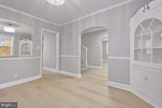 an empty room with closet and windows