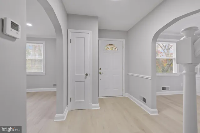 an empty room with windows and closet