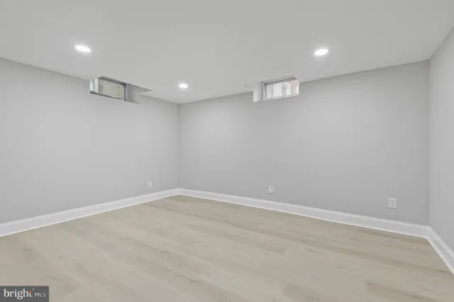 a view of a house with a large window and wooden fence