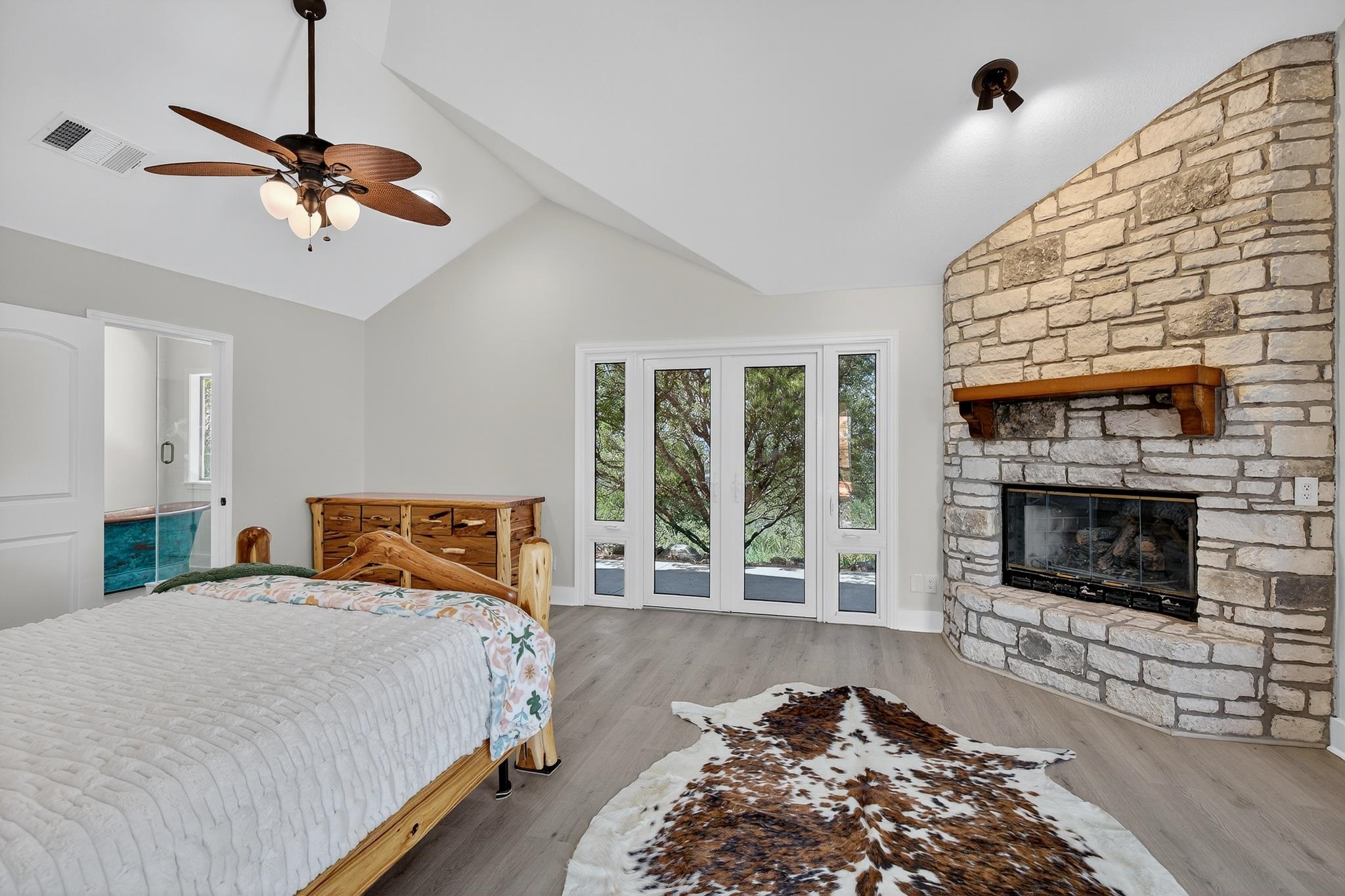 95 Gateway North Marble Falls, TX 78654 - Photo 14 of 30 a bedroom with a bed and a fireplace
