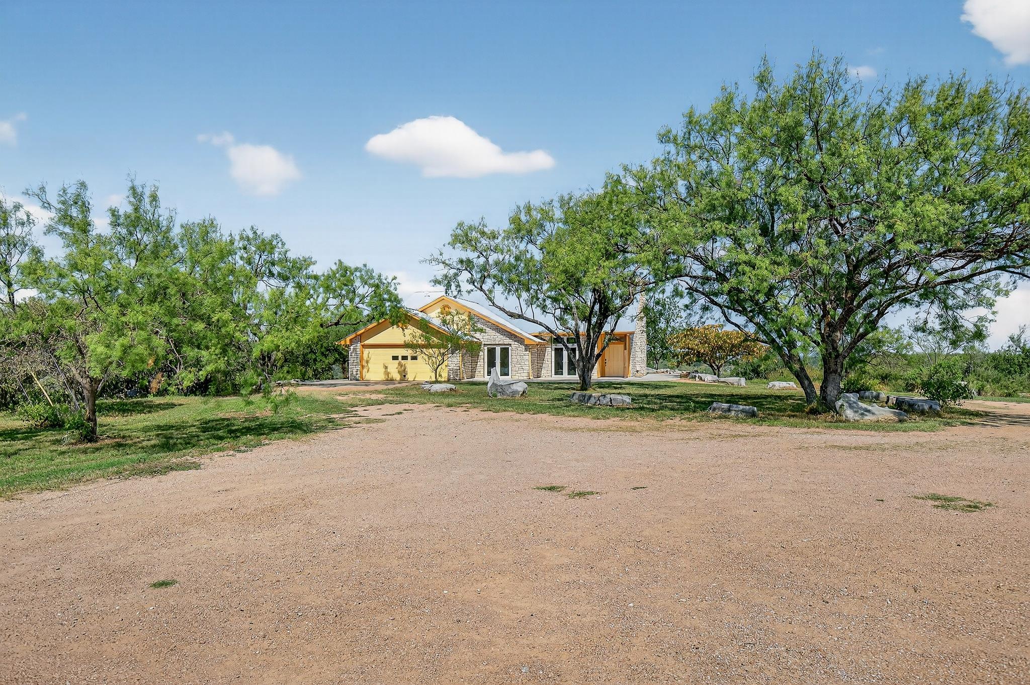 95 Gateway North Marble Falls, TX 78654 - Photo 2 of 30 a view of a house with a yard and large trees