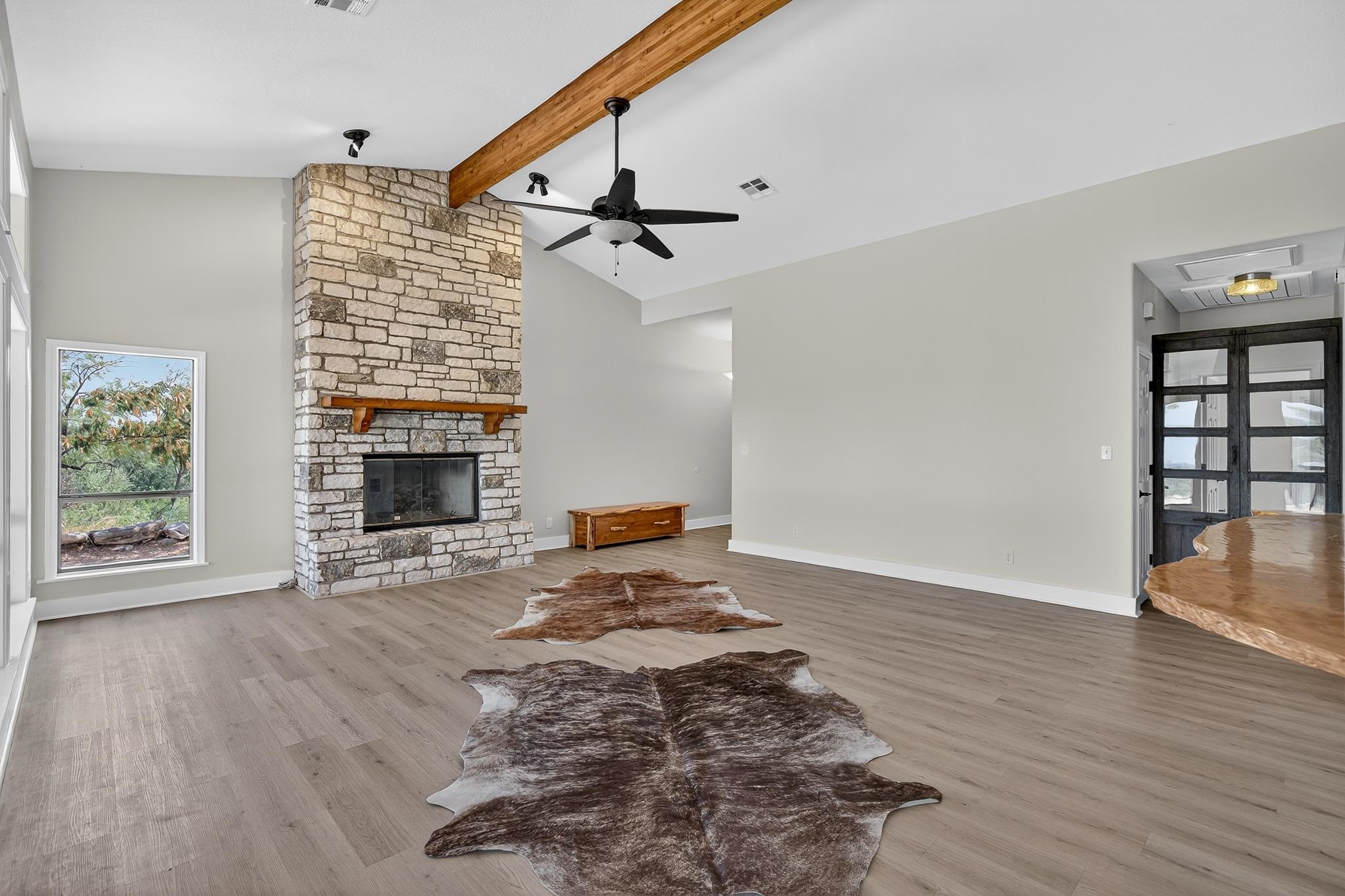 95 Gateway North Marble Falls, TX 78654 - Photo 6 of 30 a view of an empty room with wooden floor fireplace and a window