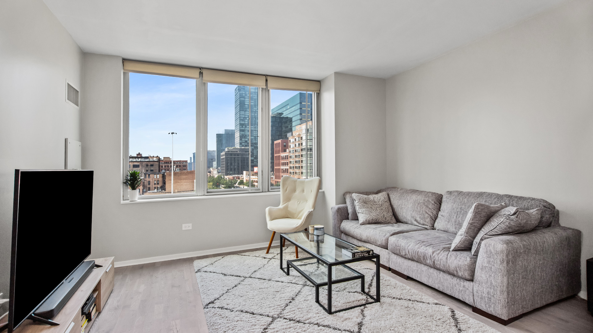659 West Randolph Street, Unit 510 Chicago, IL 60661 - Photo 2 of 10 a living room with furniture and a flat screen tv