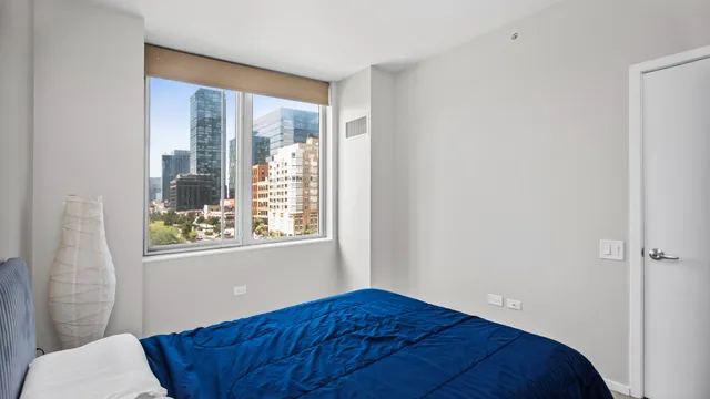 a bedroom with a bed and a window