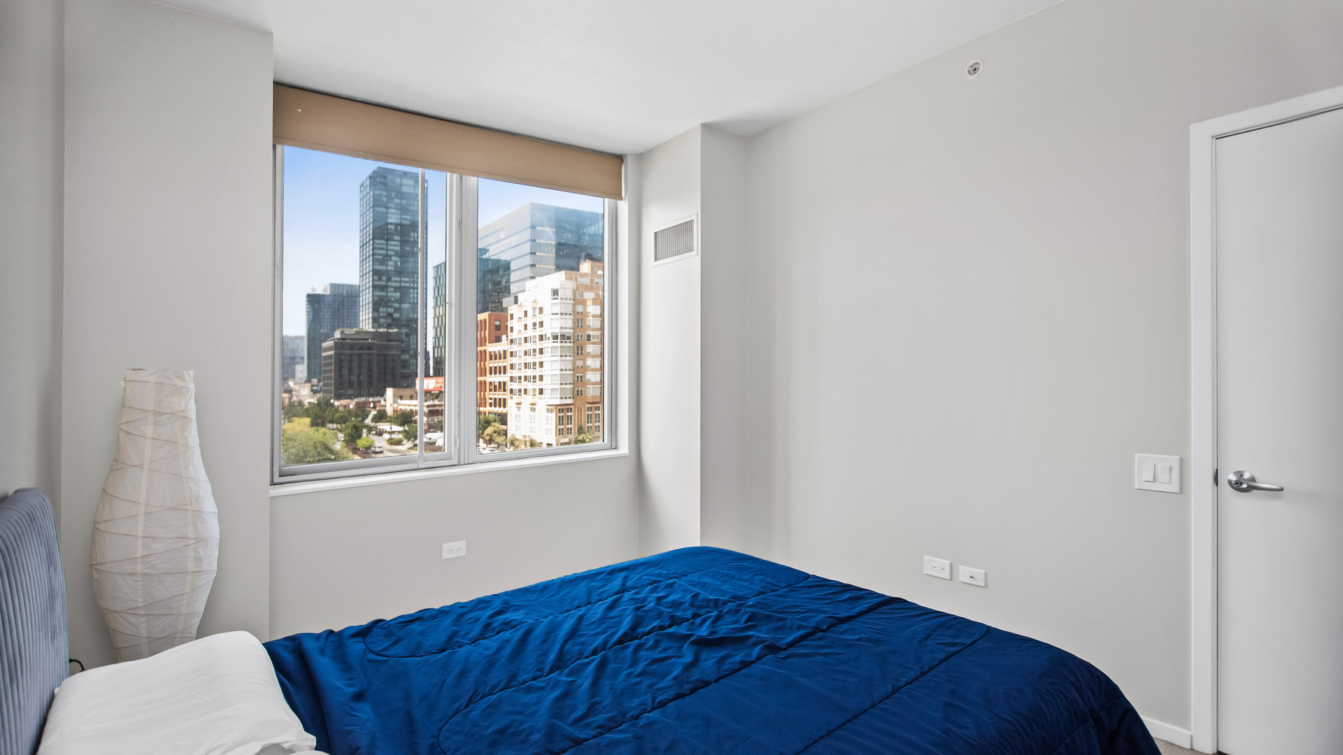 659 West Randolph Street, Unit 510 Chicago, IL 60661 - Photo 4 of 10 a bedroom with a bed and a window