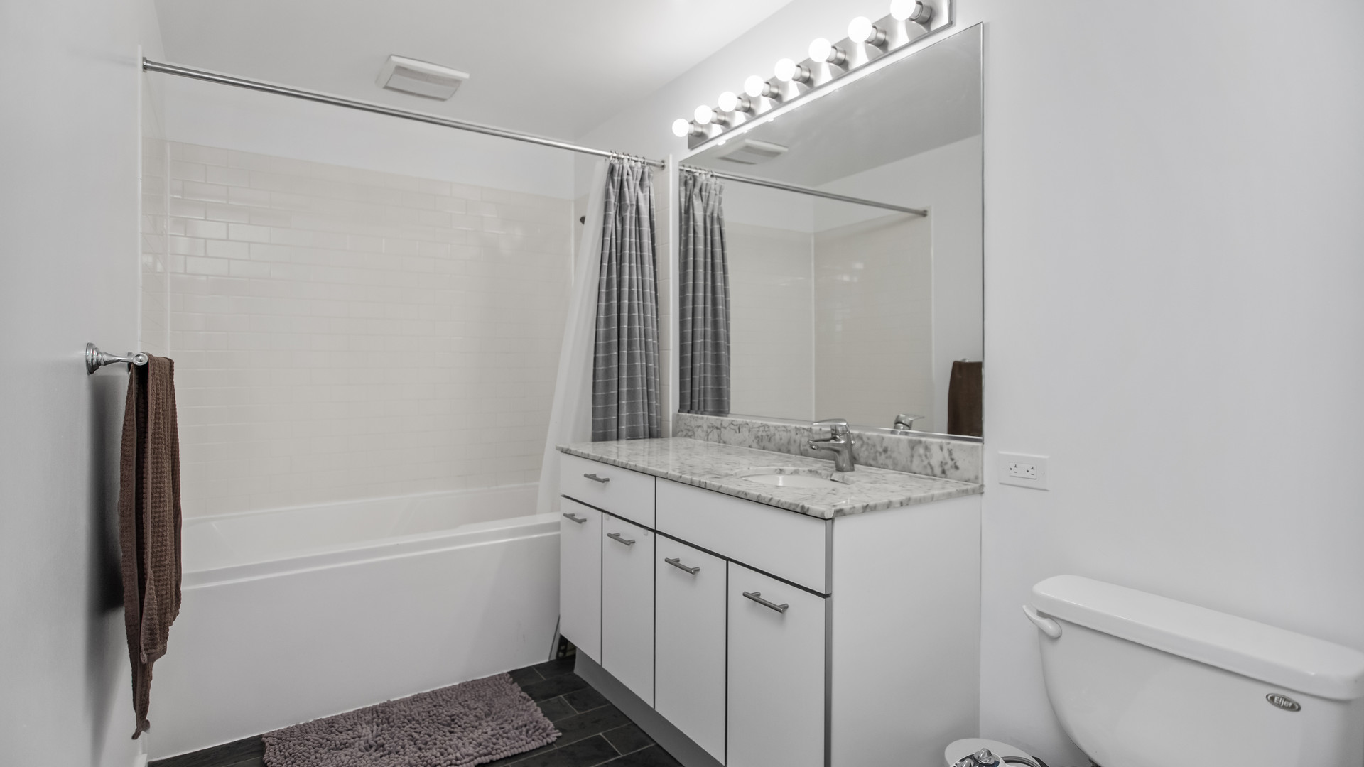 659 West Randolph Street, Unit 510 Chicago, IL 60661 - Photo 5 of 10 a bathroom with a granite countertop sink toilet and shower