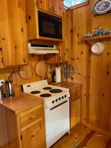 a kitchen with stove and cabinets