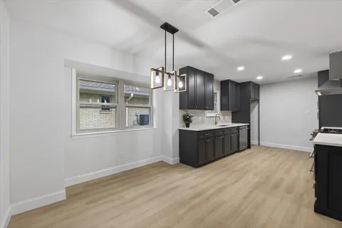 an empty room with window and ceiling fan