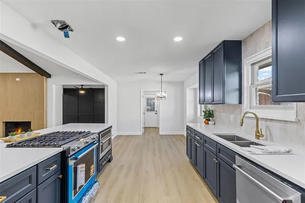 a kitchen with a sink stove and refrigerator