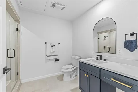 a spacious bathroom with a sink a toilet and shower