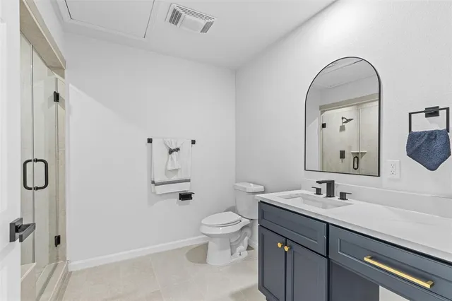 a spacious bathroom with a sink a toilet and shower