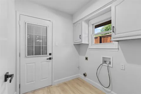 a bathroom with a tub and a window