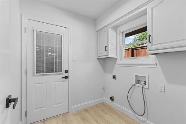 a bathroom with a tub and a window
