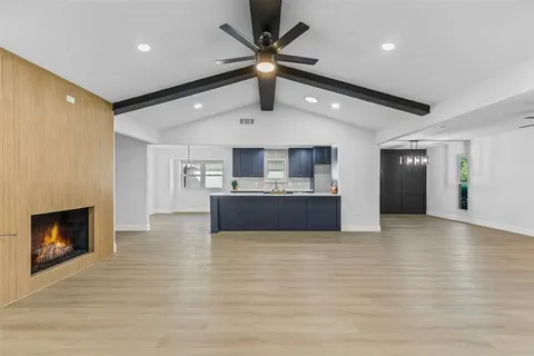 a view of kitchen with microwave and refrigerator
