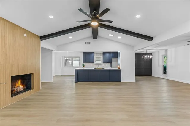 a view of kitchen with microwave and refrigerator