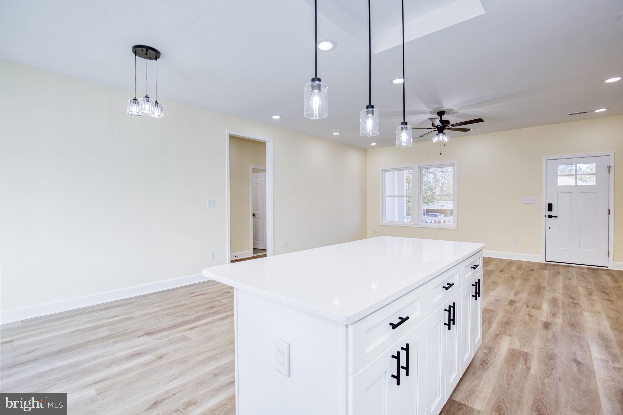 49 Poplar Lane Colonial Beach, VA 22443 - Photo 14 of 42 a room with a chandelier fan and wooden floor