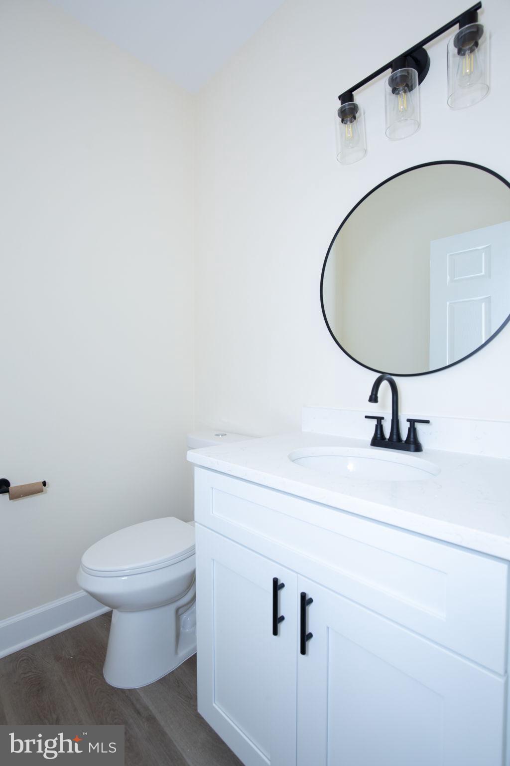 49 Poplar Lane Colonial Beach, VA 22443 - Photo 17 of 42 a bathroom with a sink a toilet and a mirror
