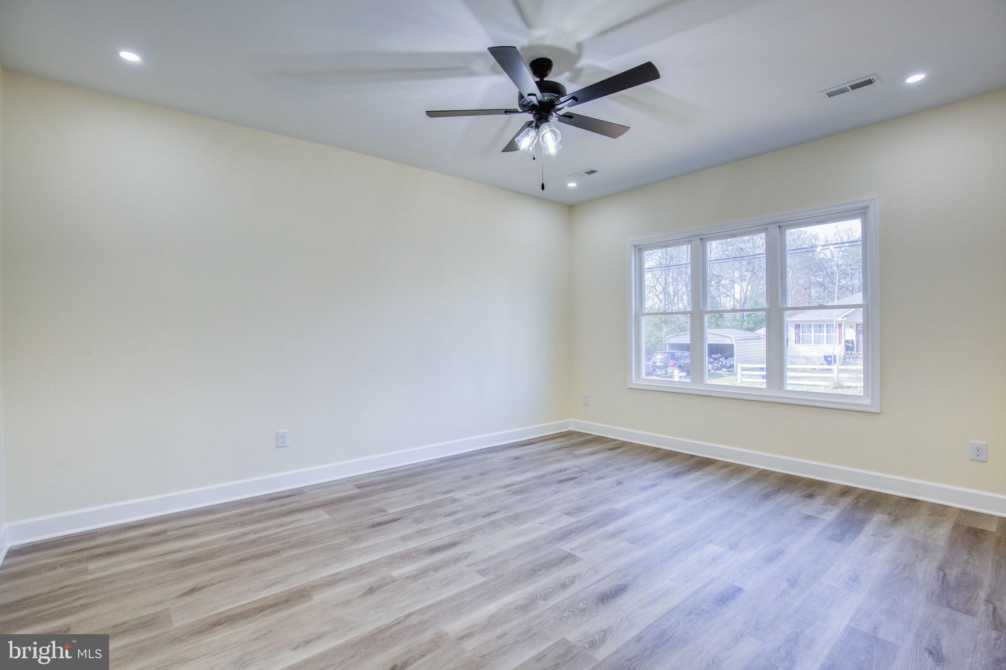 49 Poplar Lane Colonial Beach, VA 22443 - Photo 18 of 42 an empty room with wooden floor and windows