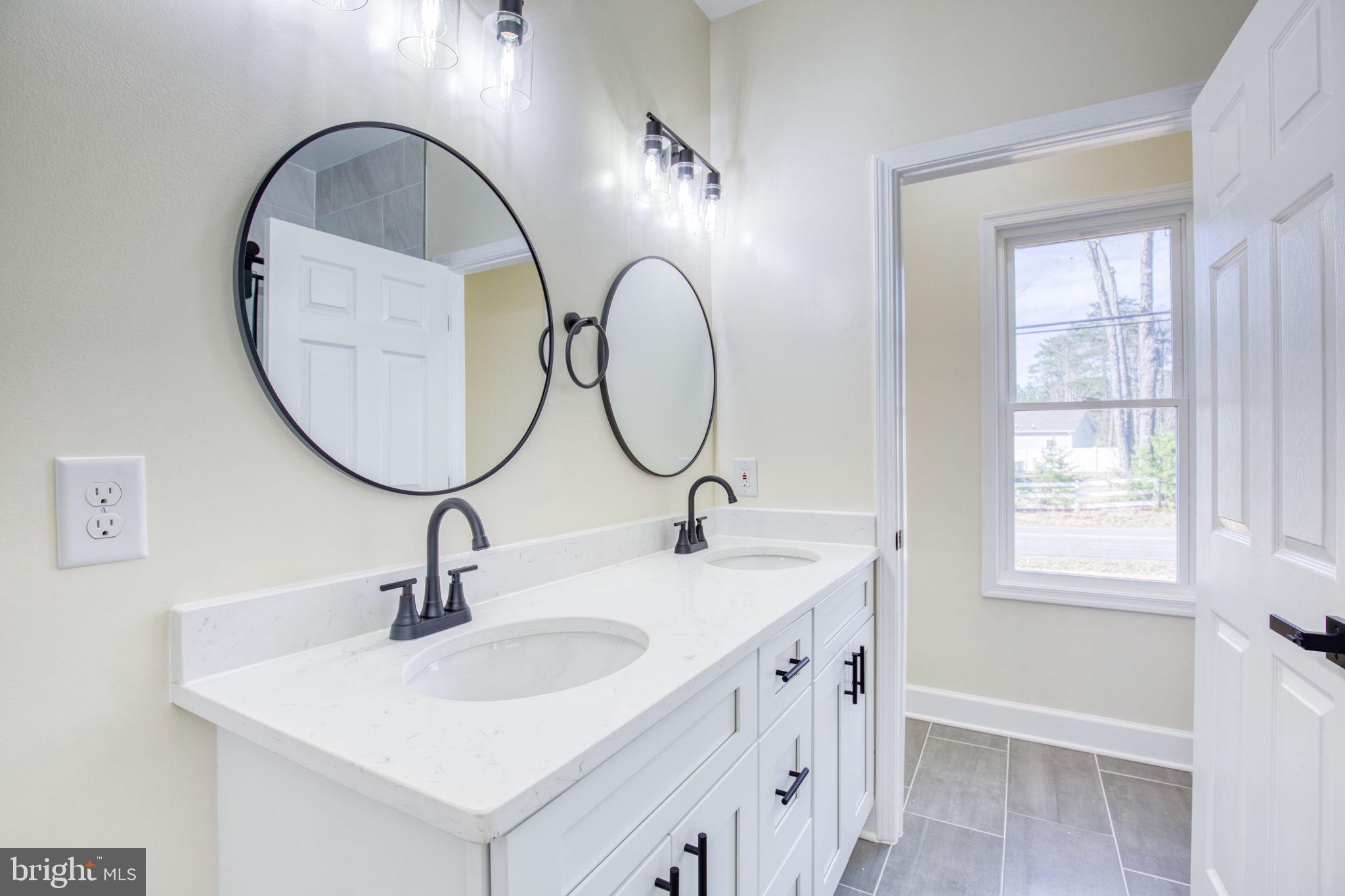 49 Poplar Lane Colonial Beach, VA 22443 - Photo 21 of 42 a bathroom with a sink and a mirror