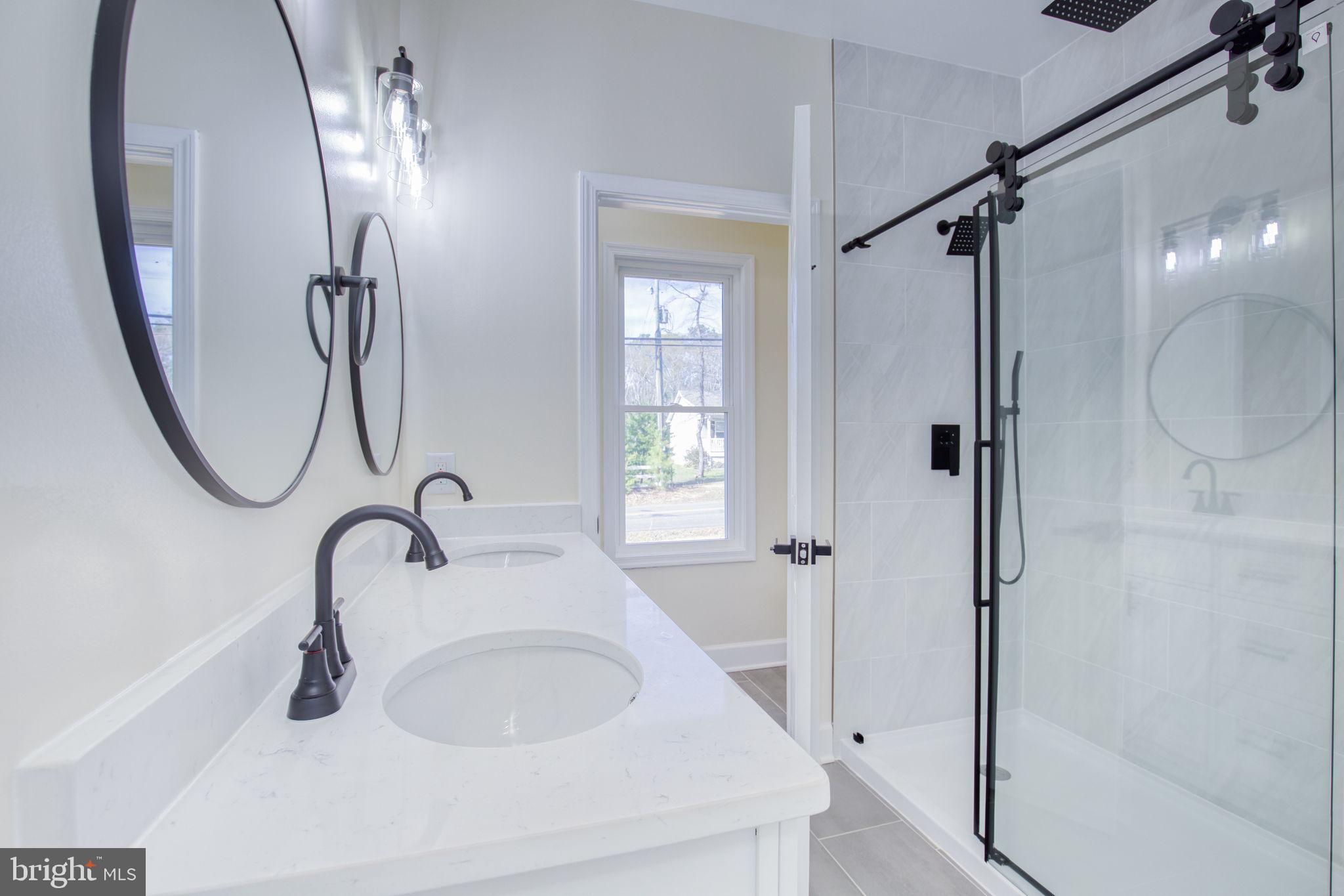 49 Poplar Lane Colonial Beach, VA 22443 - Photo 22 of 42 a bathroom with a sink and a mirror