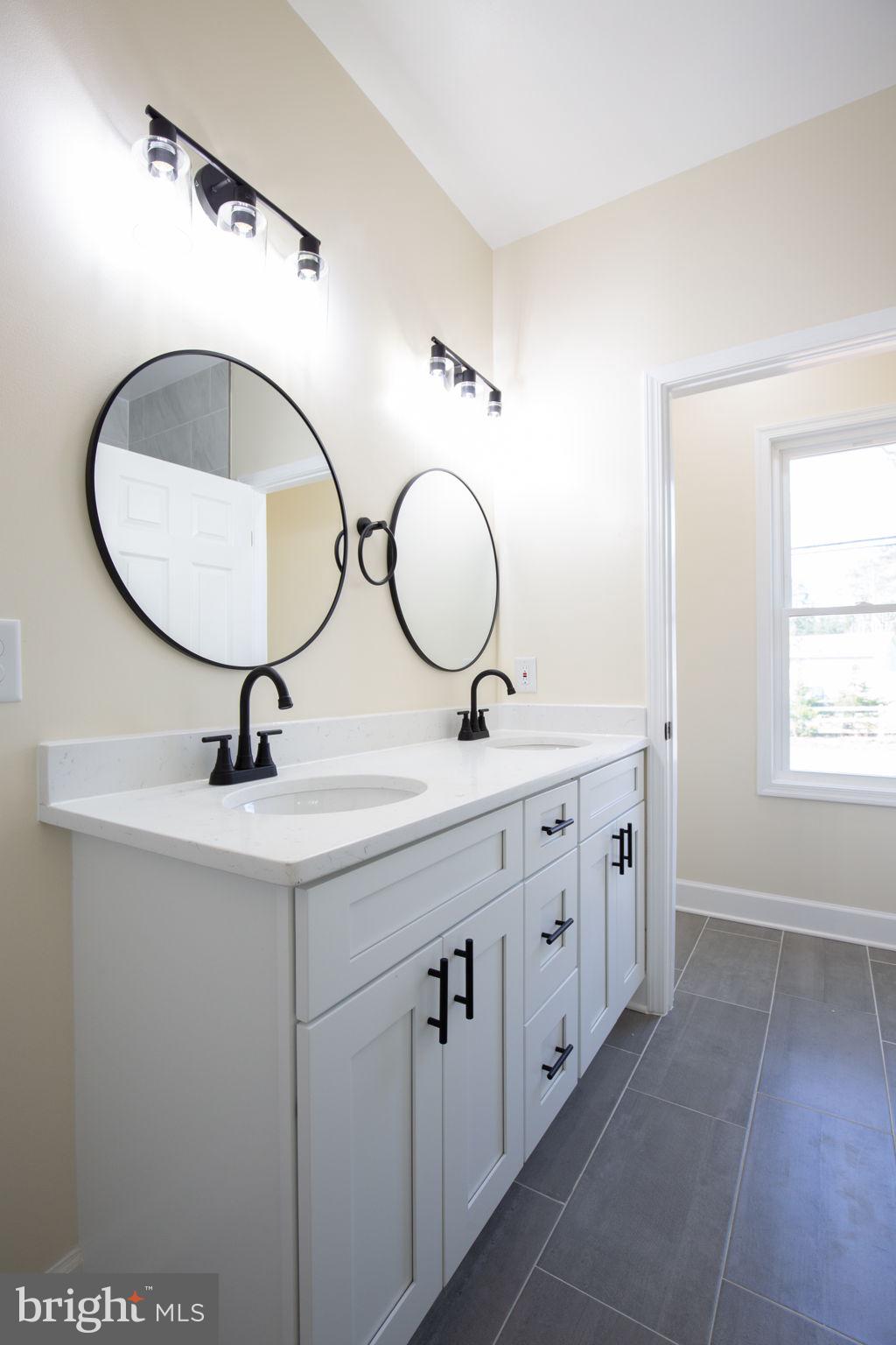 49 Poplar Lane Colonial Beach, VA 22443 - Photo 23 of 42 a bathroom with a double vanity sink and a mirror