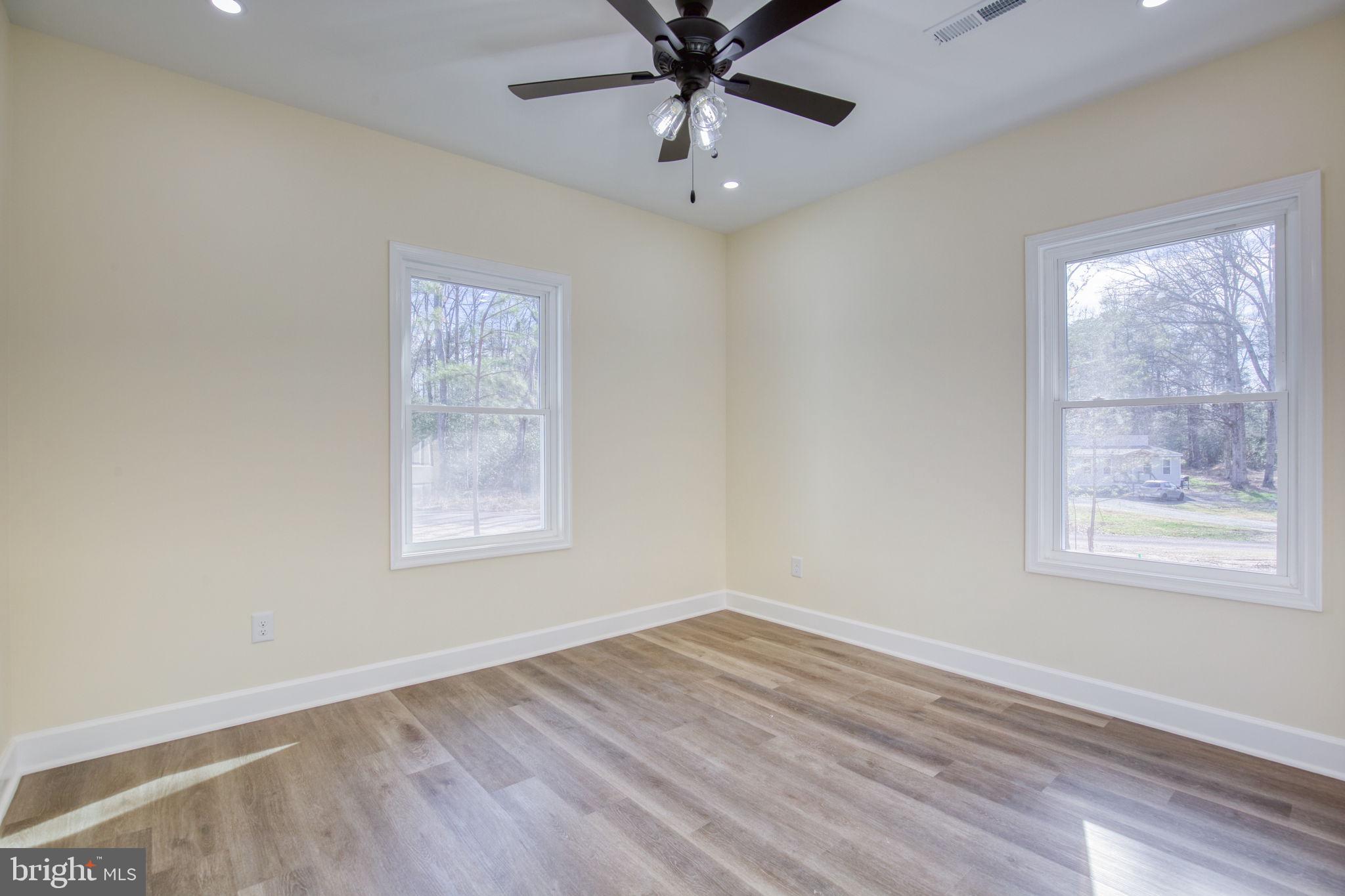 49 Poplar Lane Colonial Beach, VA 22443 - Photo 30 of 42 a view of an empty room with wooden floor and a window