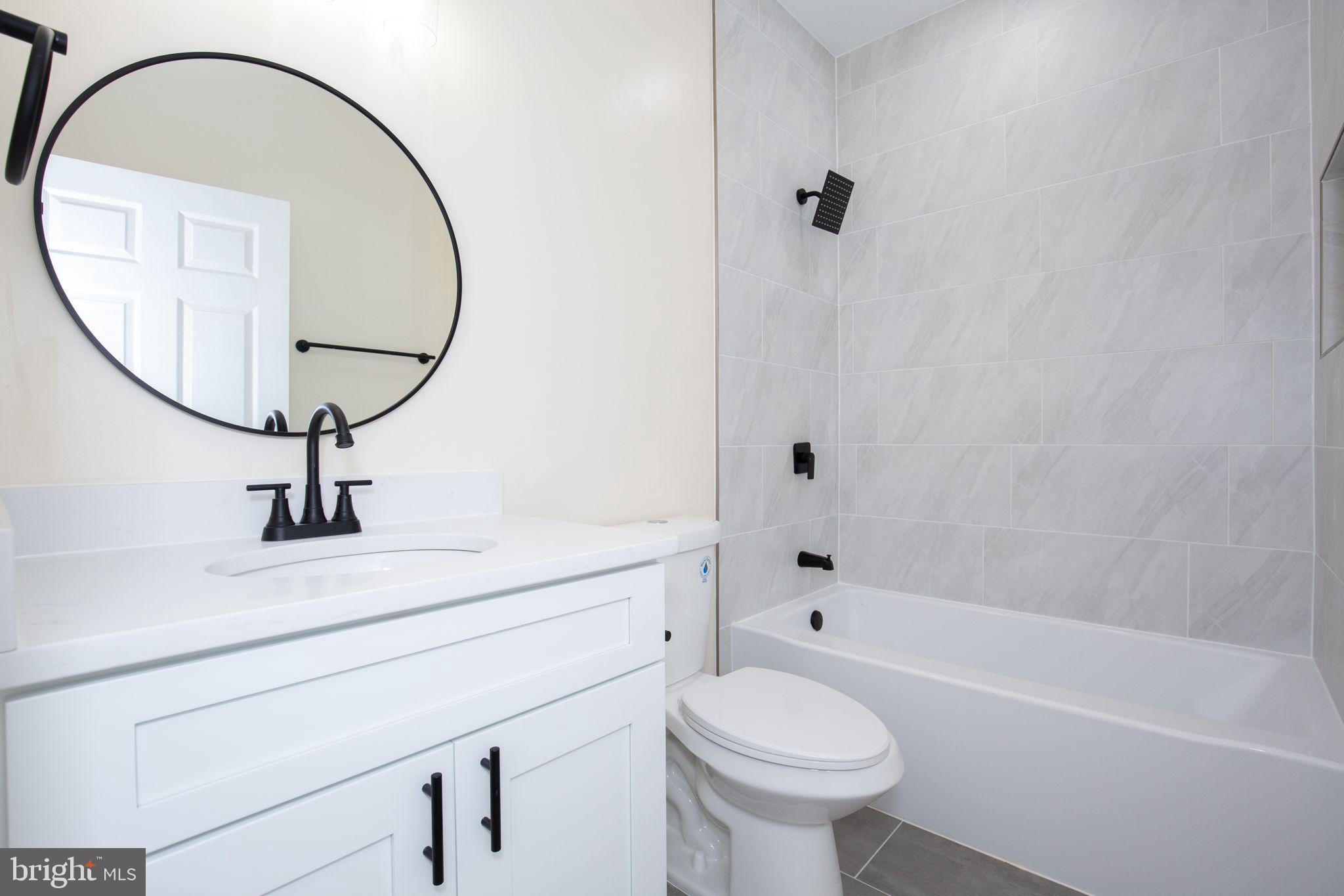 49 Poplar Lane Colonial Beach, VA 22443 - Photo 33 of 42 a bathroom with a sink a toilet and a mirror