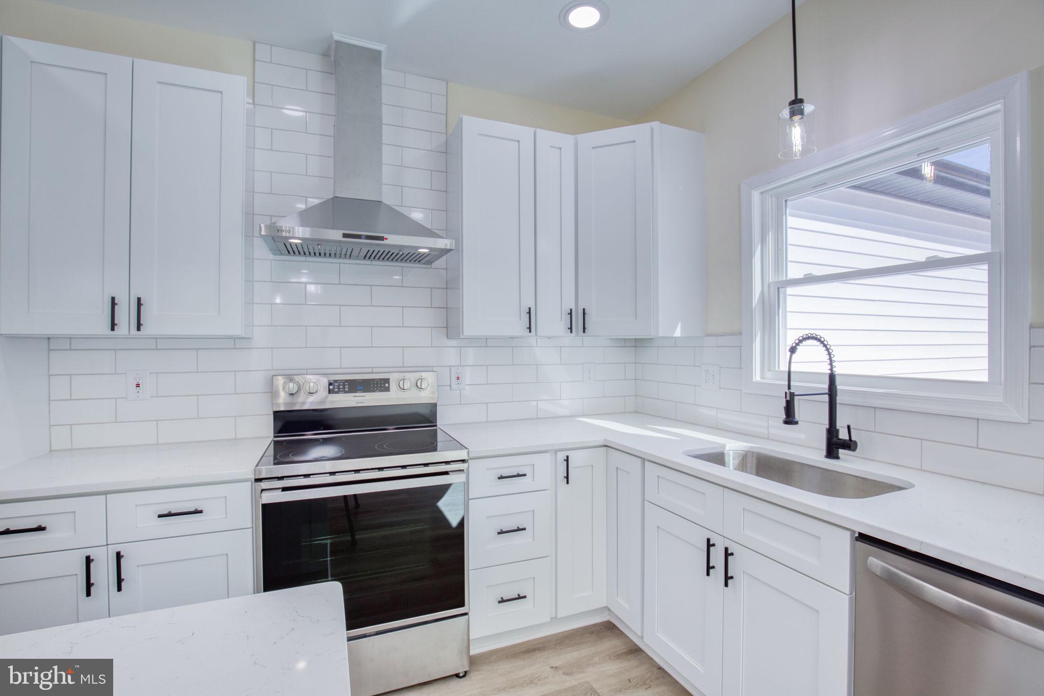 49 Poplar Lane Colonial Beach, VA 22443 - Photo 5 of 42 a kitchen with cabinets appliances a sink and a window