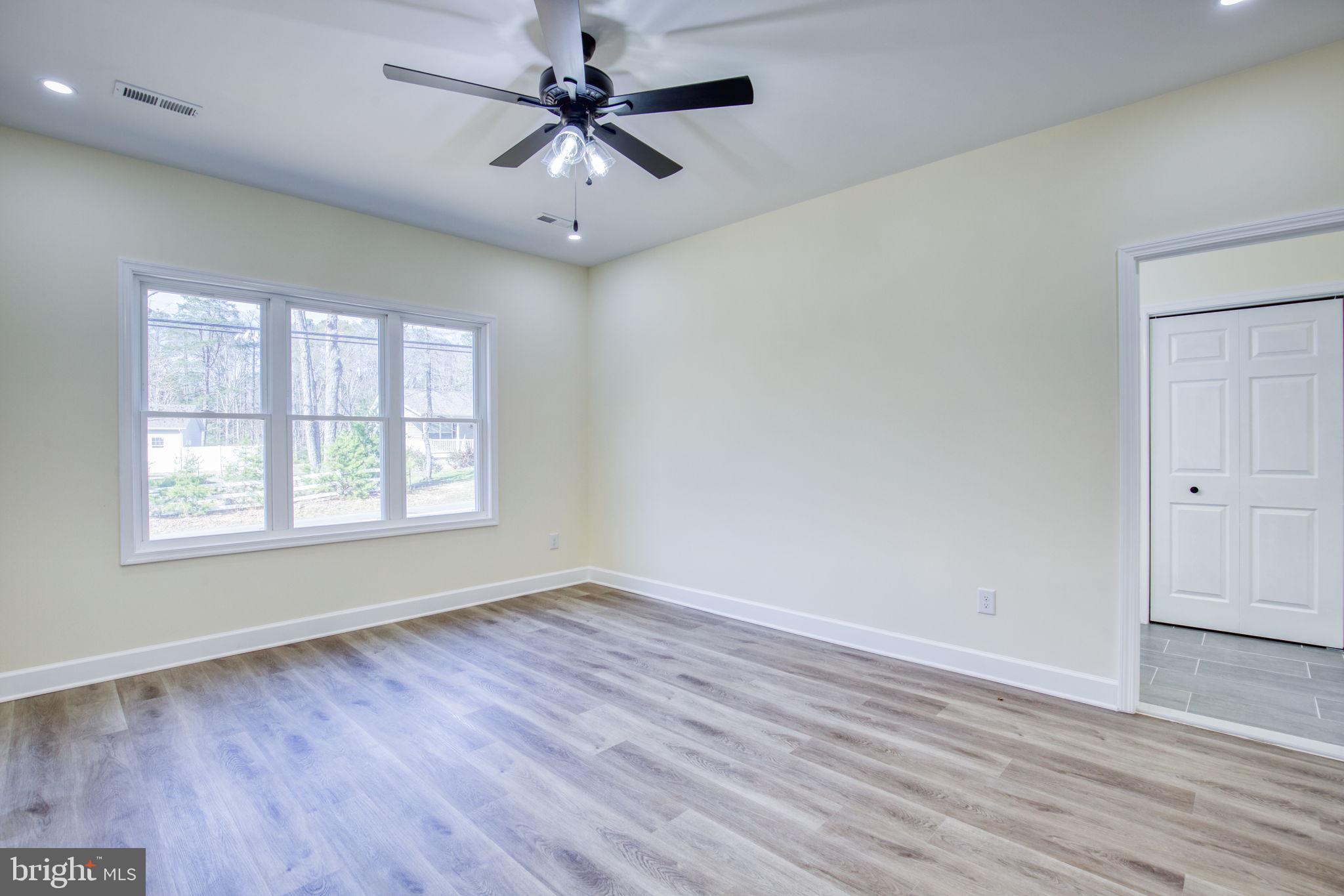 49 Poplar Lane Colonial Beach, VA 22443 - Photo 7 of 42 wooden floor in an empty room with a window