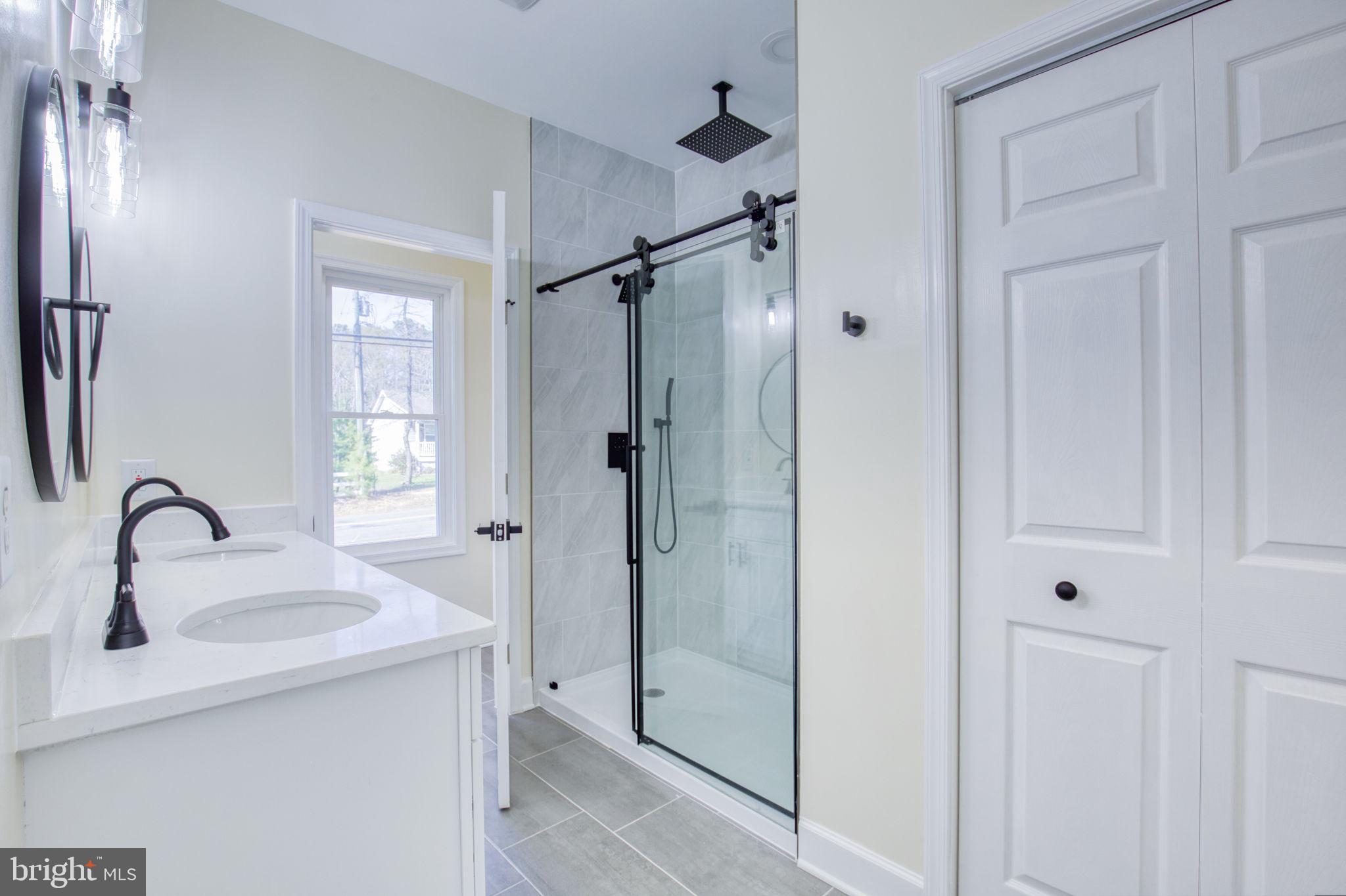49 Poplar Lane Colonial Beach, VA 22443 - Photo 8 of 42 a bathroom with a sink and shower