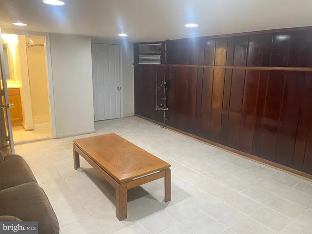 a room with pool table and a glass door shower