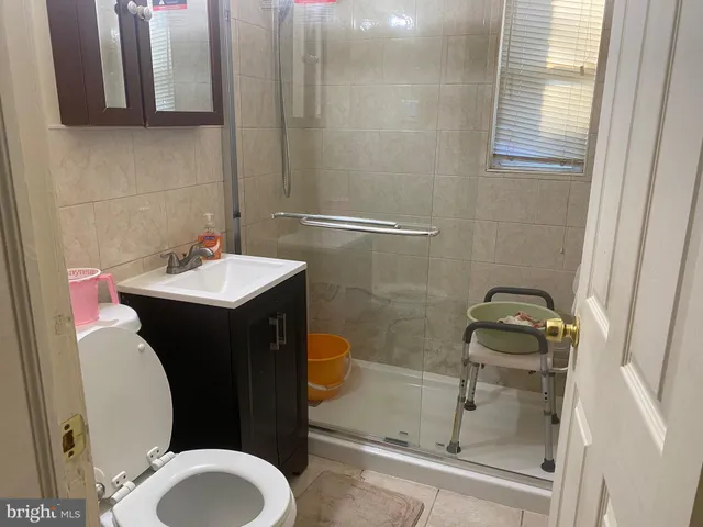 a bathroom with a sink a toilet and mirror