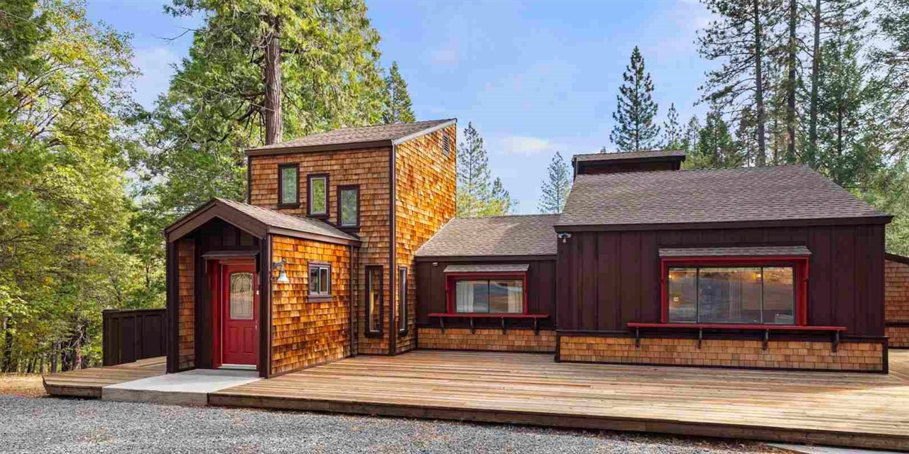 a view of house with a door and tree s