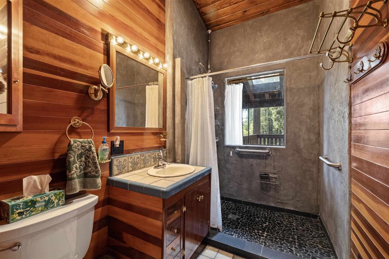 25833 Lyons Dam Road Twain Harte, CA 95383 - Photo 26 of 60 a bathroom with a sink a toilet and shower