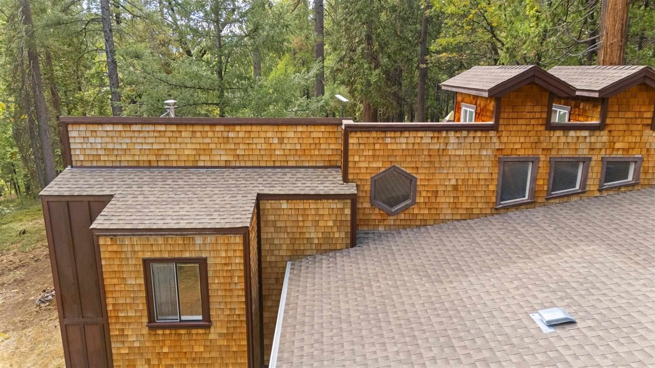 25833 Lyons Dam Road Twain Harte, CA 95383 - Photo 57 of 60 a view of a brick house with large space and wooden fence