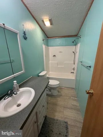 a bathroom with a sink and mirror with toilet